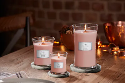 rose wood large medium and mini hourglass candles placed on table