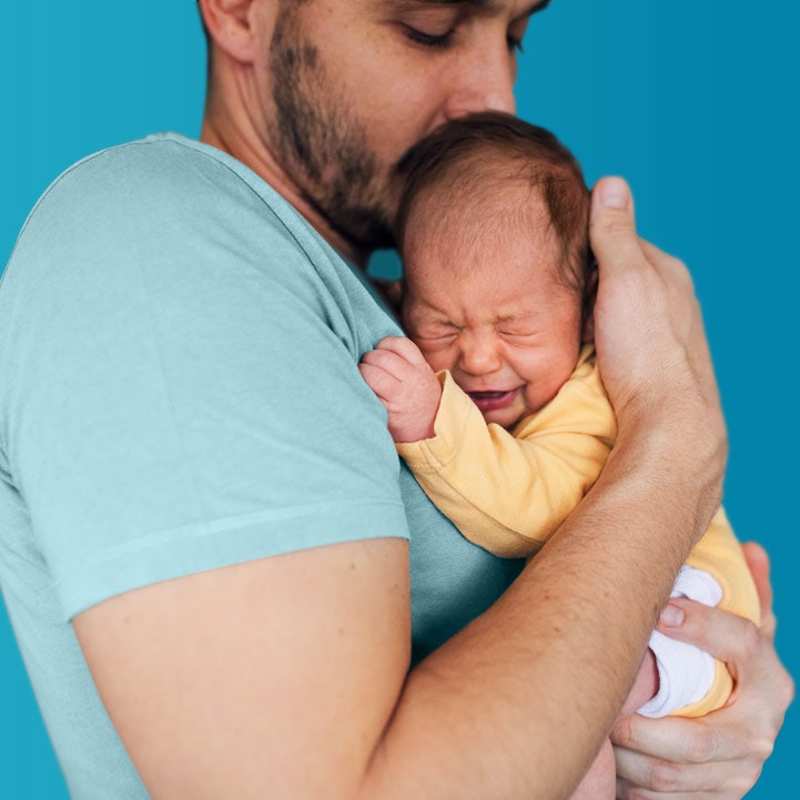 man holds colicky baby