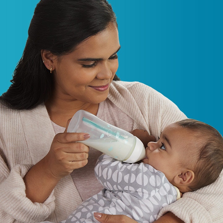 Mother bottle feeding baby