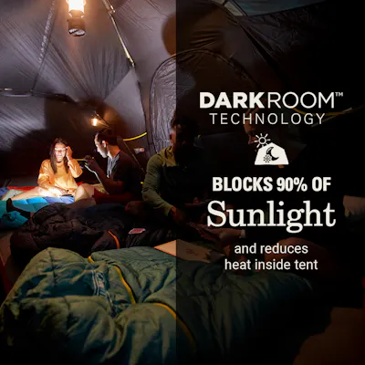Three people inside tent that has Darkroom technology