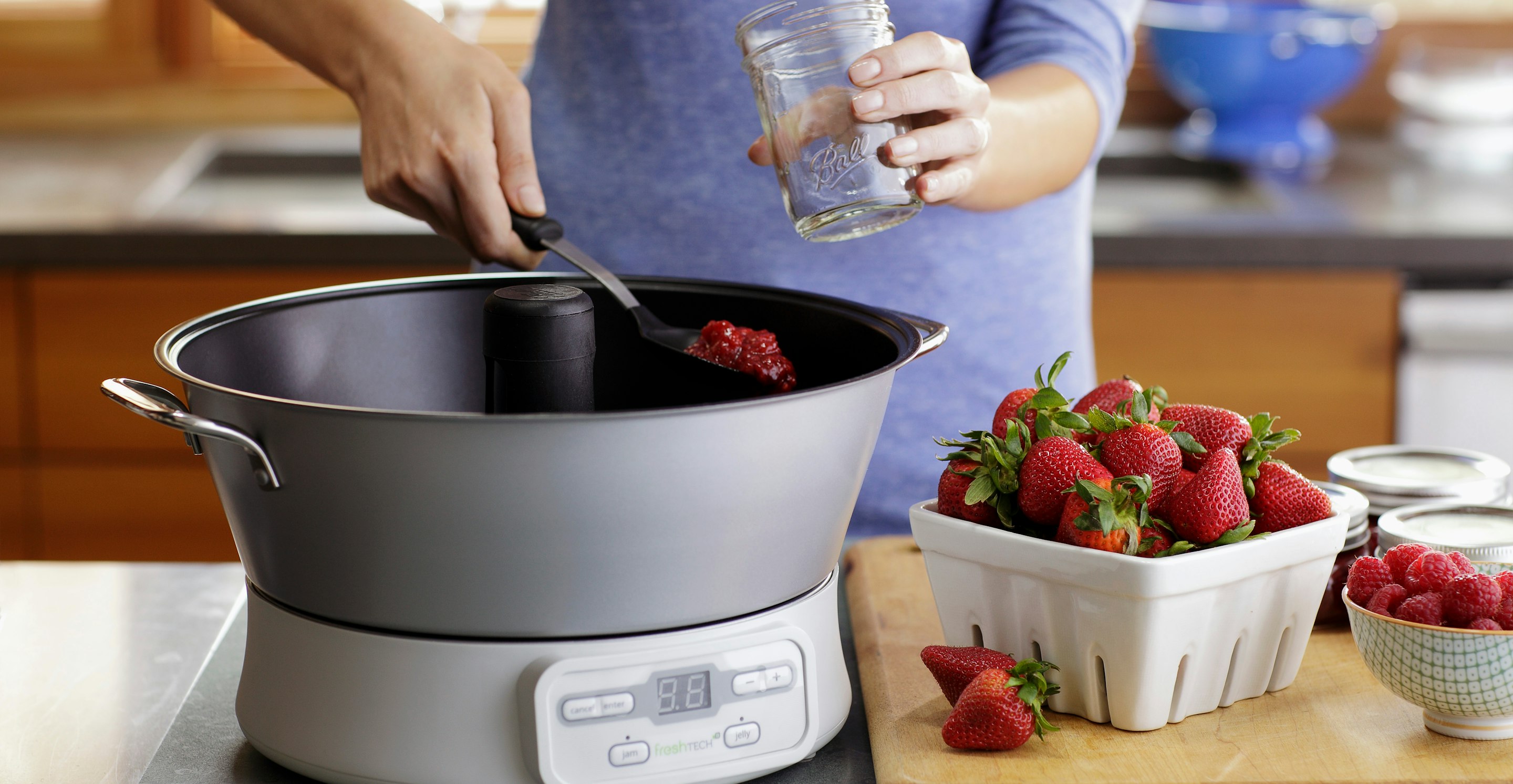 A canning system home appliance being used for fruit canning in kitchen