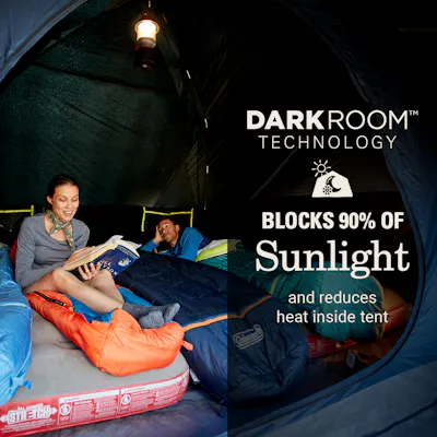 Two people inside tent that has Darkroom technology